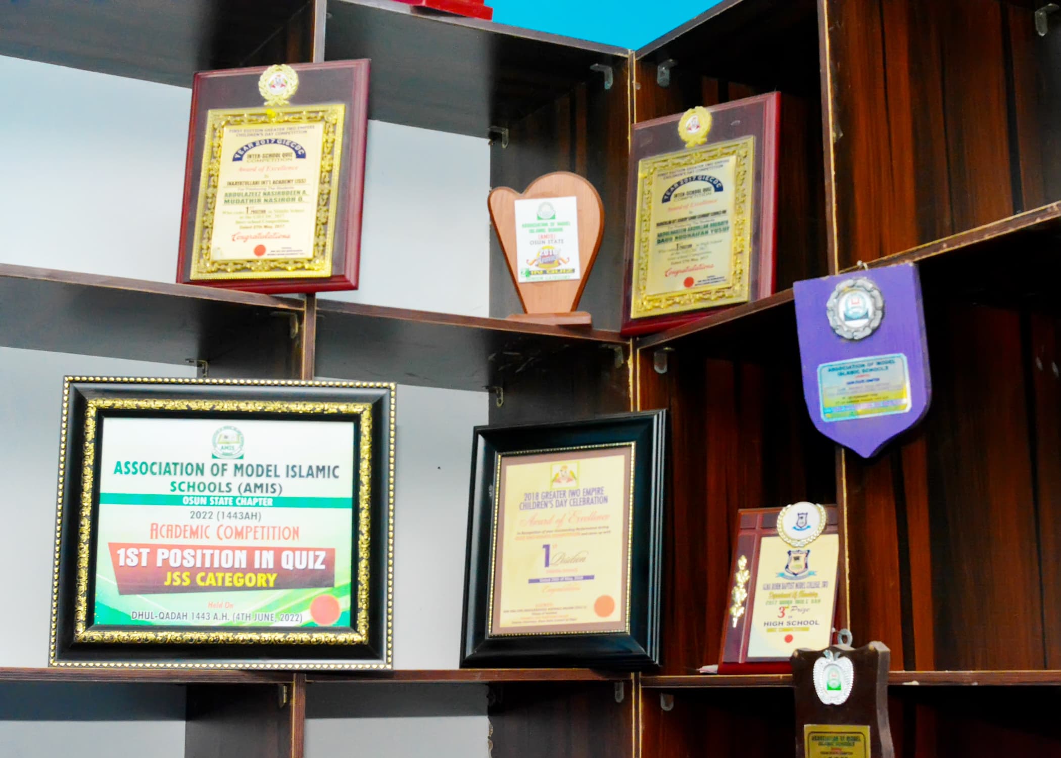 A display of awards and certificates earned by Inaayatullah learners