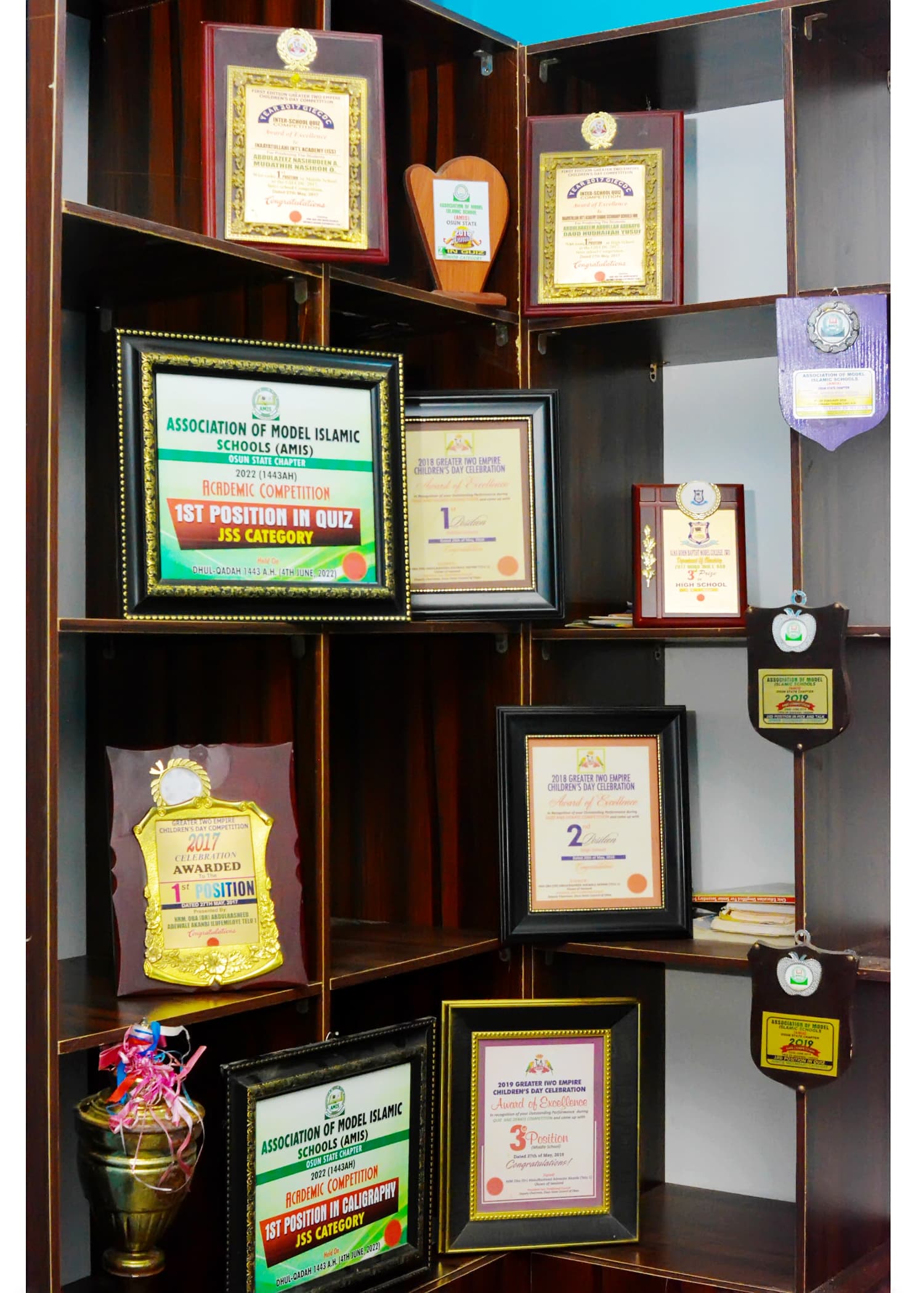 A collection of academic awards, trophies and certificates earned by Inaayatullah learners