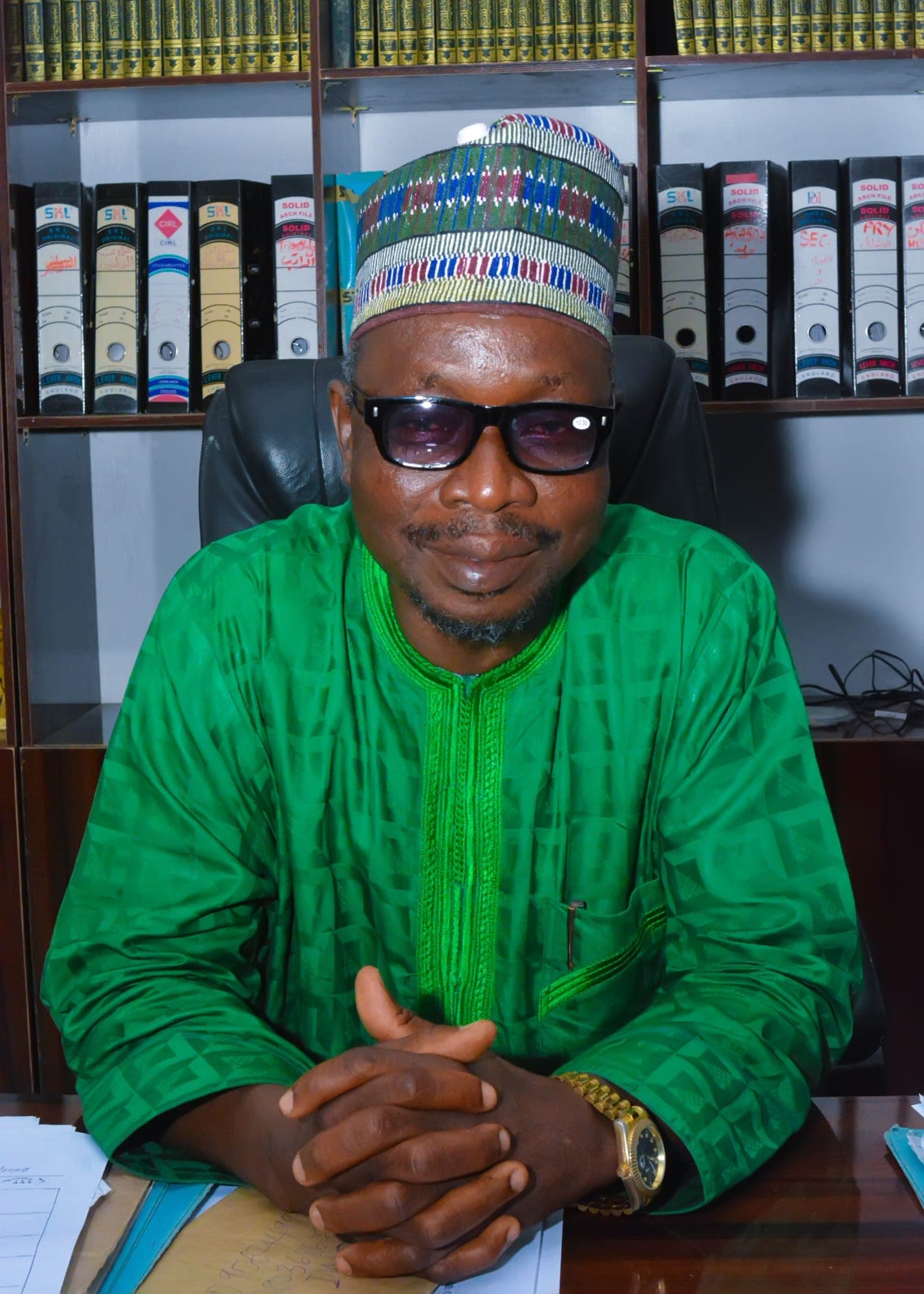 Dr. Tawfeeq Abdul Ganniy Abdul Rauf Arowolo Oloba, Head Admin, seated at his desk